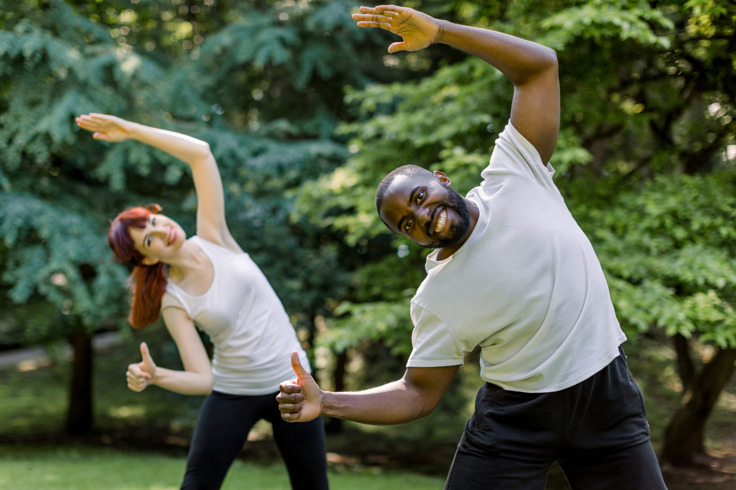 man and woman in recovery trying a new yoga class