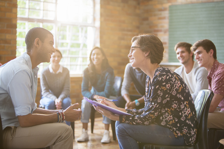 A man sharing his story of recovery in a group therapy session