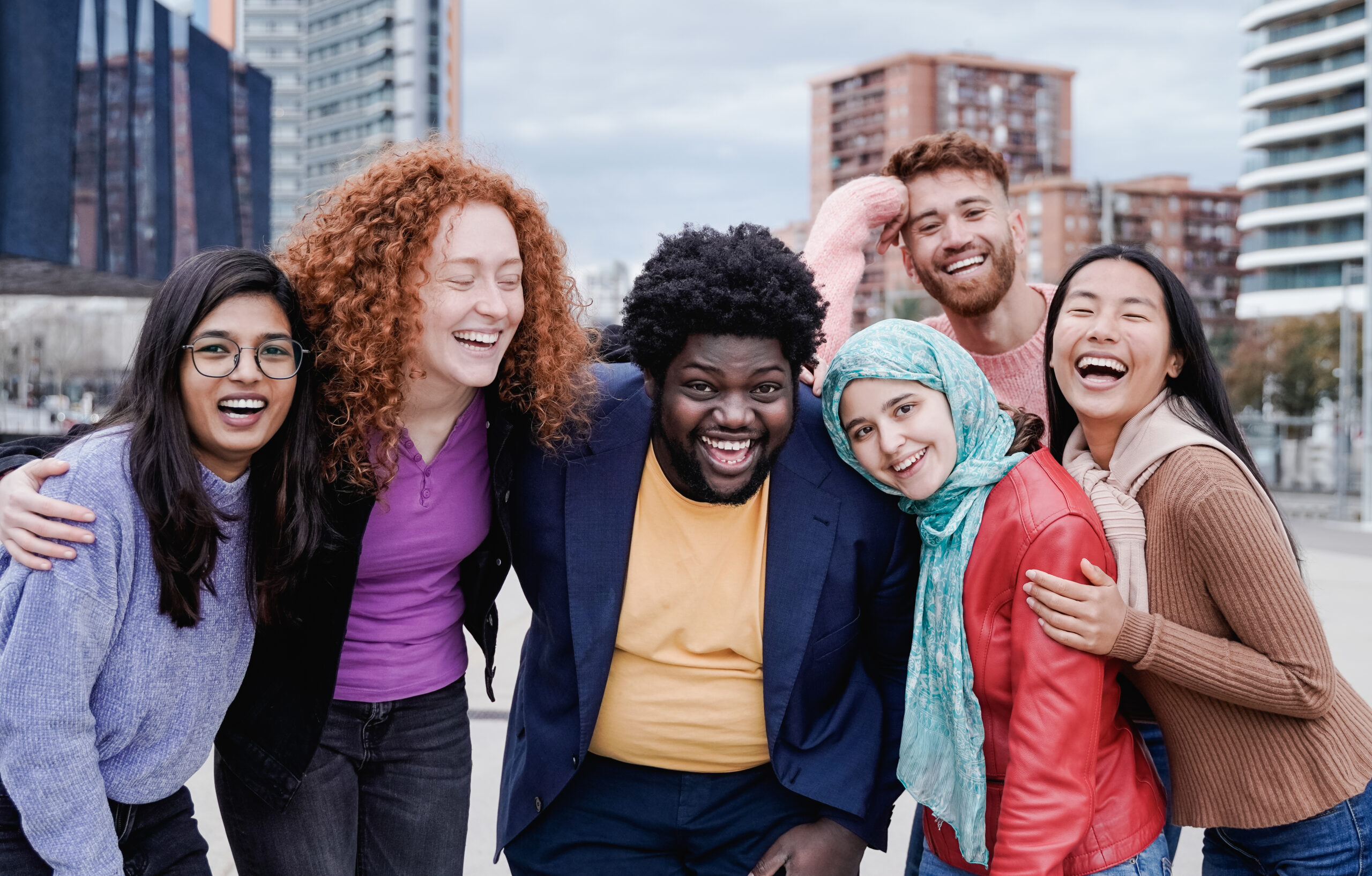 Multiracial happy friends in recovery having fun outdoor in the city