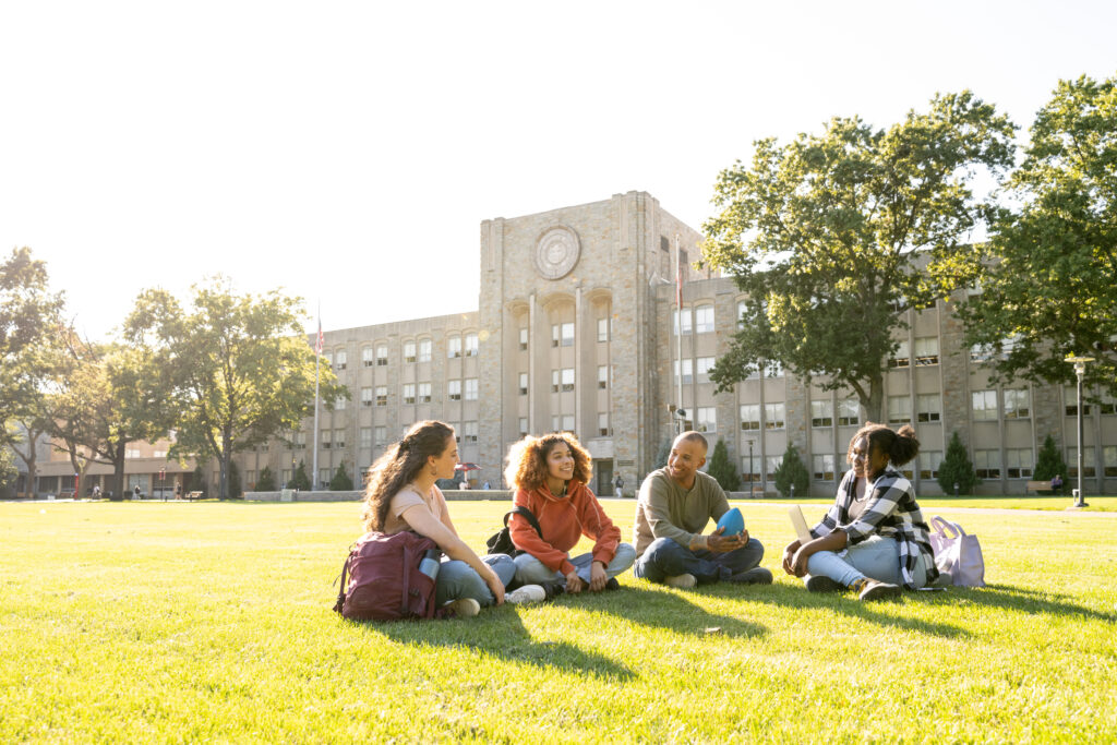 University students hanging out in campus main lawn